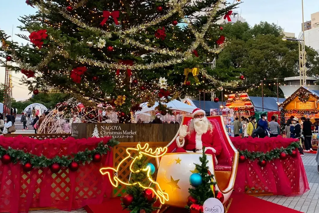 Santa seated in a sleigh beneath the giant Christmas tree at the Nagoya Christmas Market in Sakae, Hisaya Odori Park.