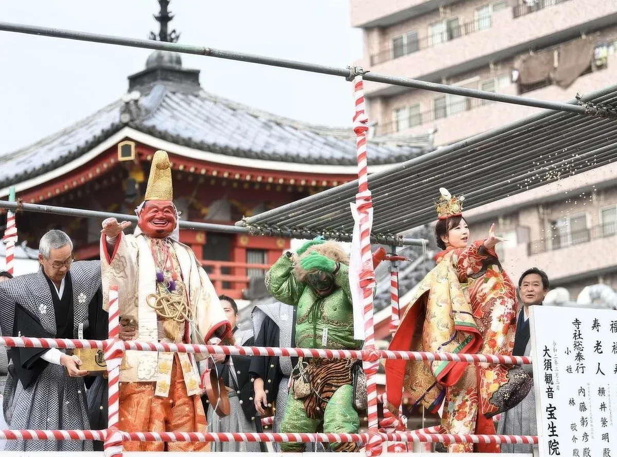People in traditional and oni costumes throwing beans from the stage at Osu Kannon during Setsubun in Nagoya.